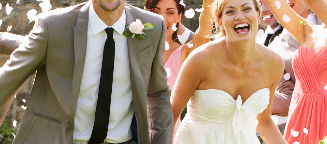 Guests Throwing Confetti Over Bride And Groom